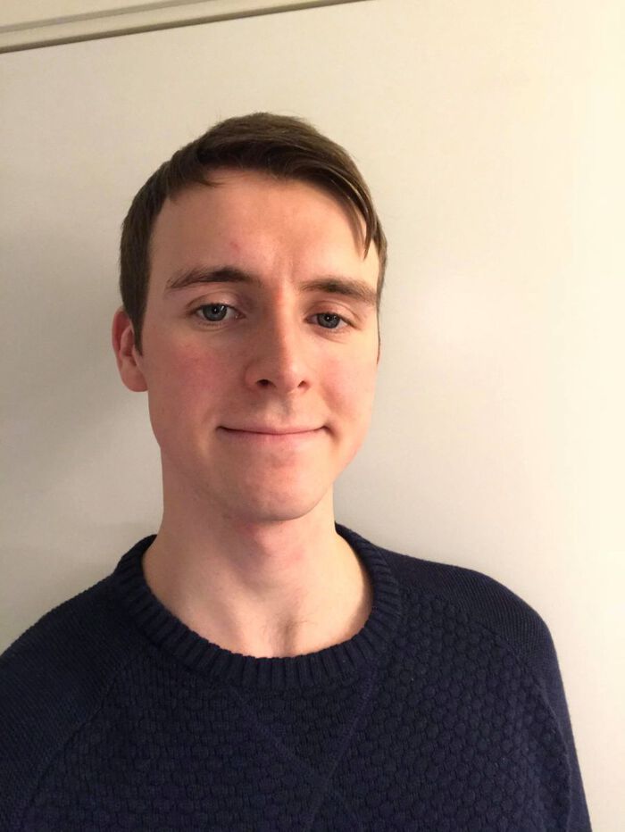 portrait photo of a young smiling man