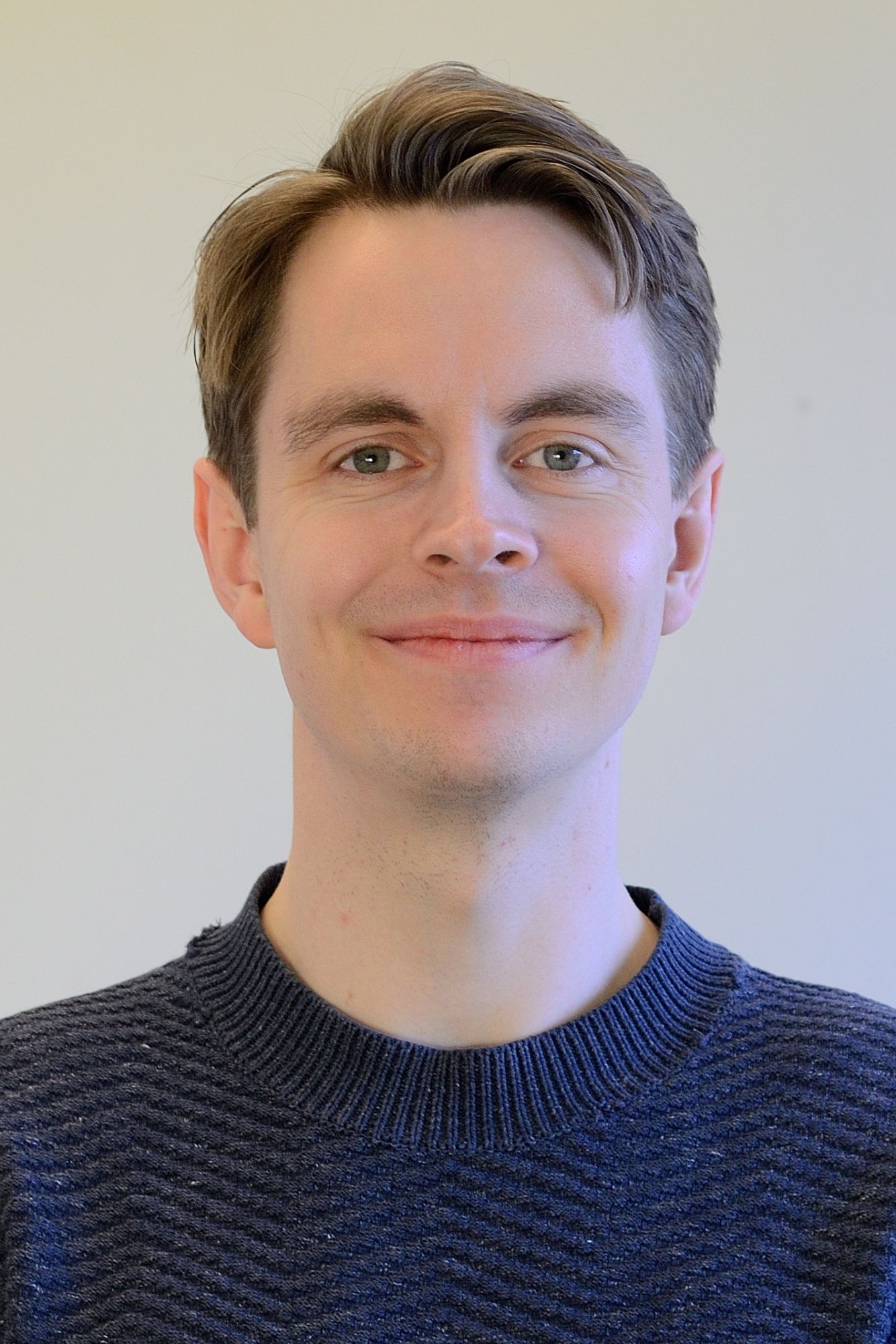 portrait photo of a young smiling man