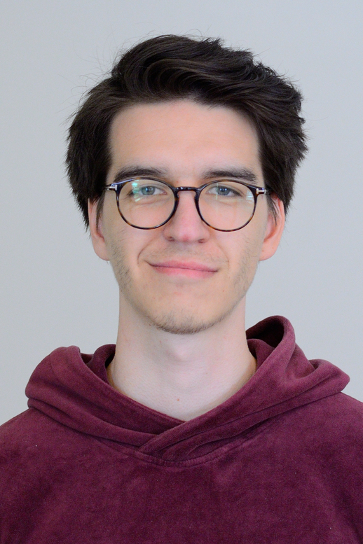 portrait image of a young man with glasses and dark hair