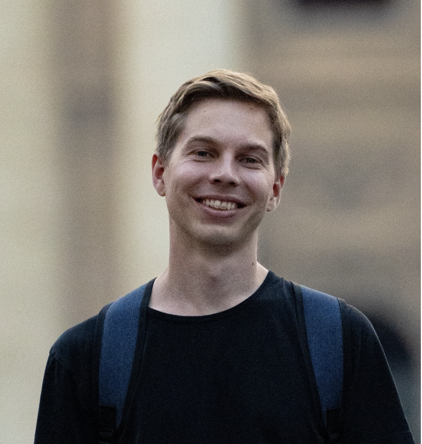 portrait image of a young smiling man