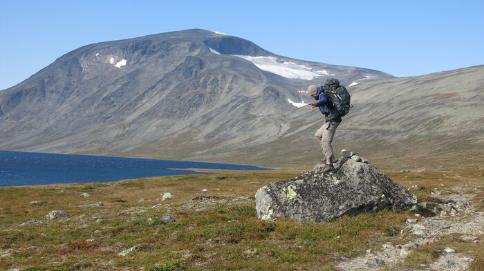 image of a young man standing on a rock in the mountain area of Jotunheimen