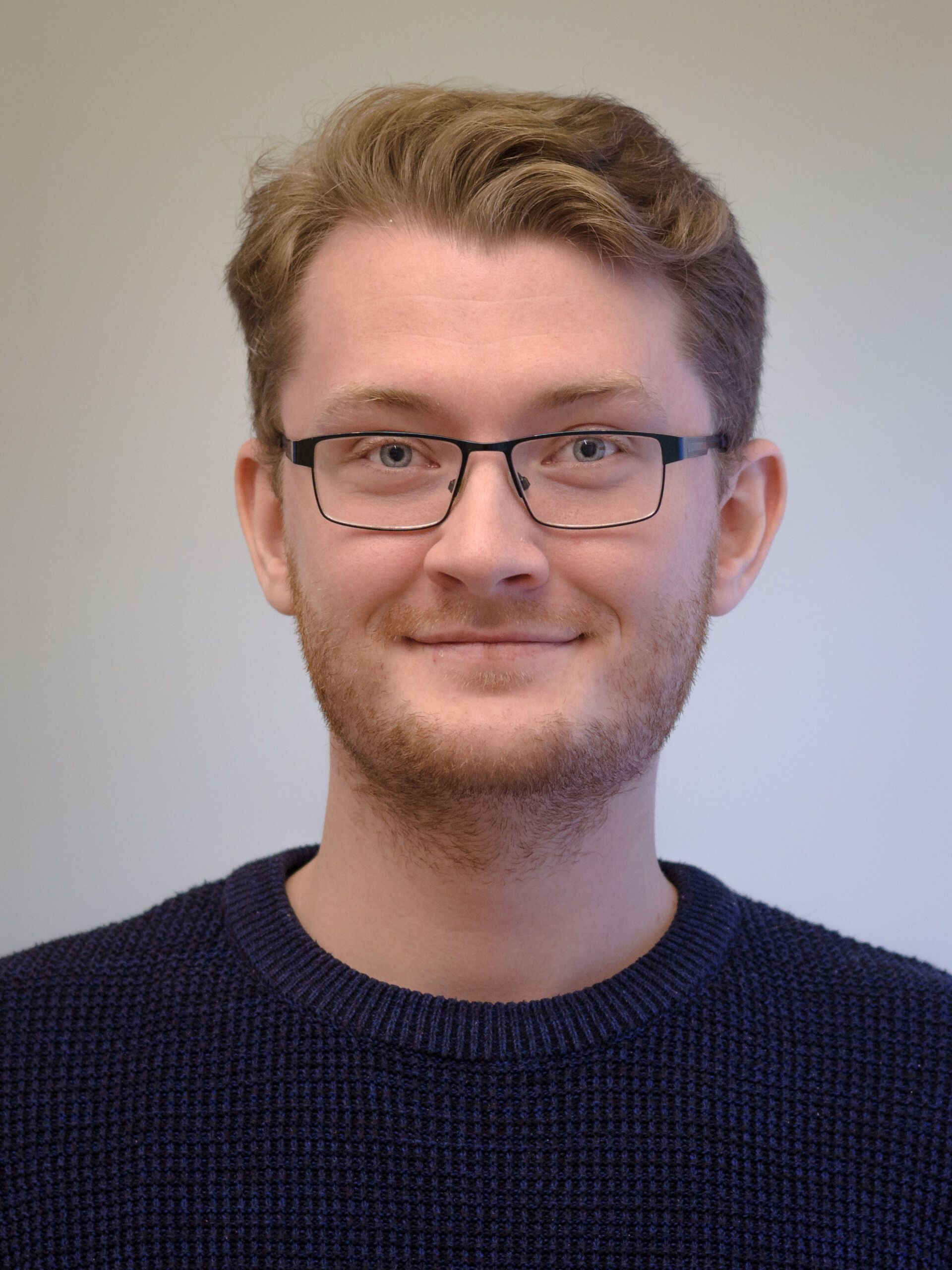 portrait photo of a young man with glasses