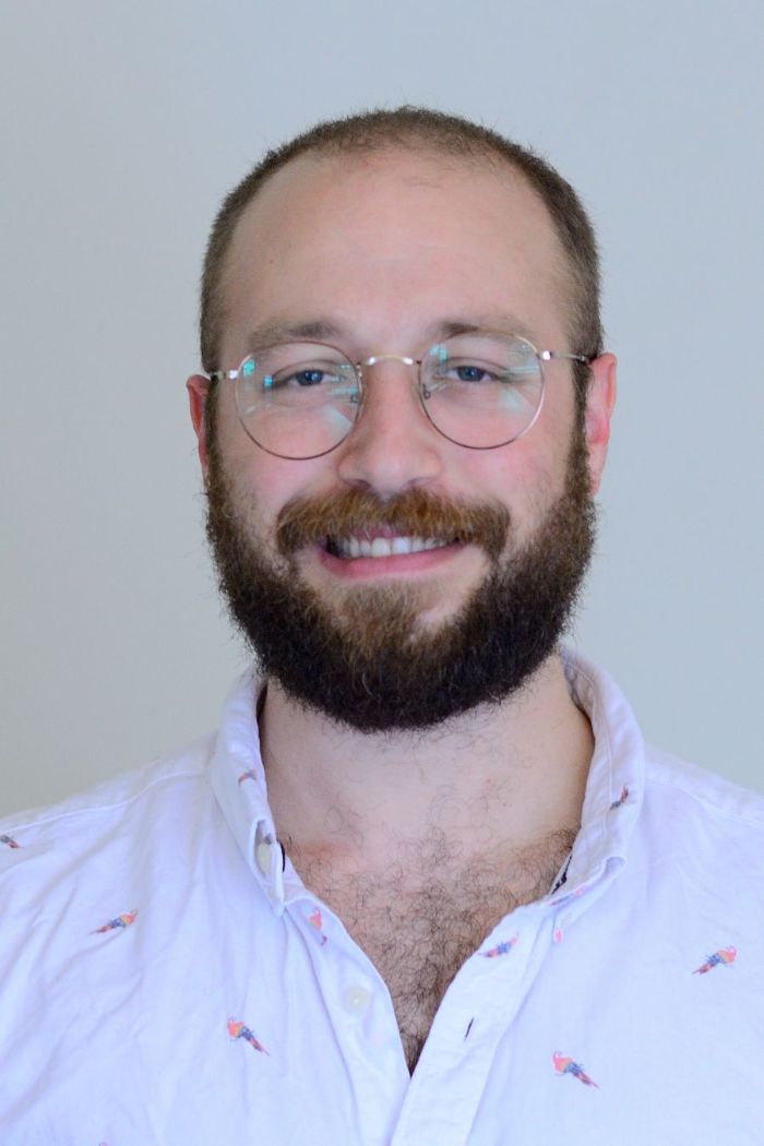 portrait photo of a young man with glasses and beard