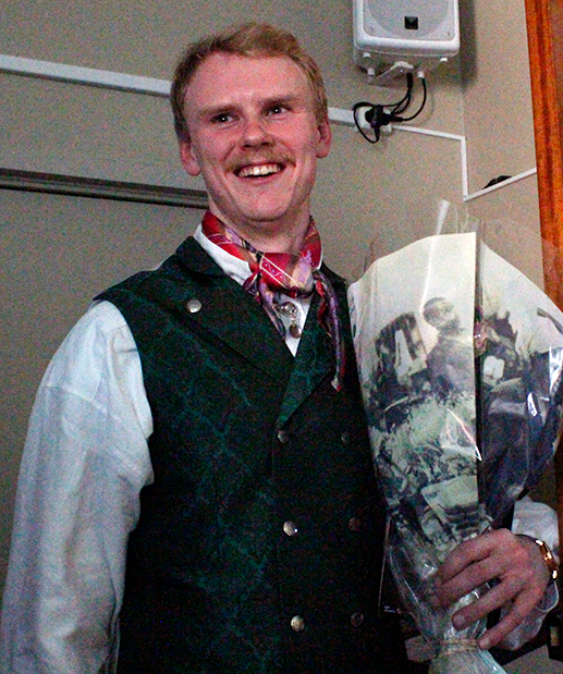Young happy man with flowers