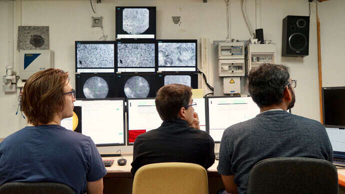Scientists looking at screens