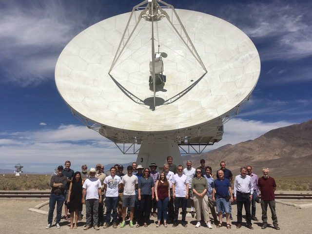 group photo in front of a radio antenna