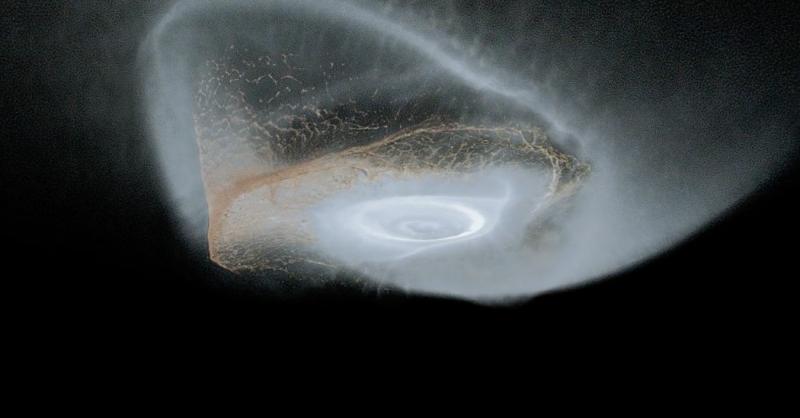 simulation of dust and gas forming rings of Saturn on a black background