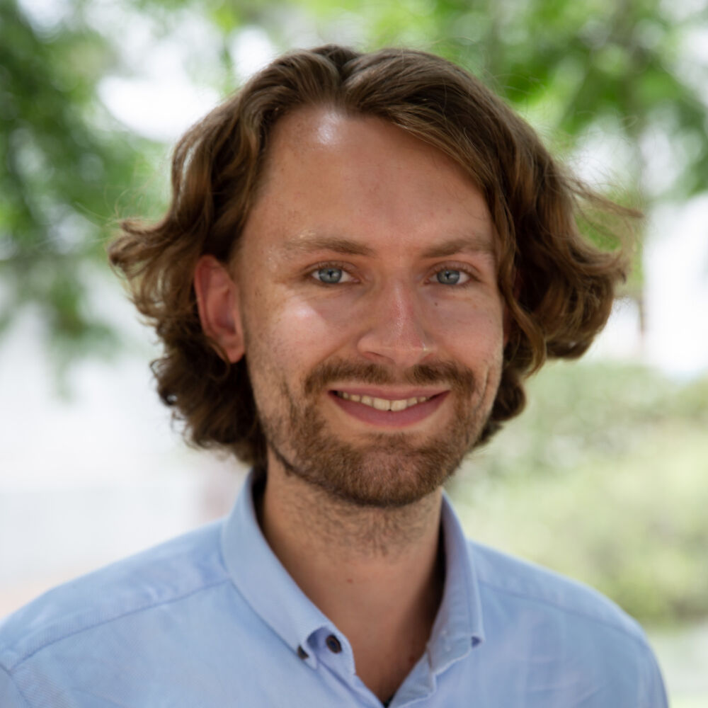 portrait photo of a young smiling man
