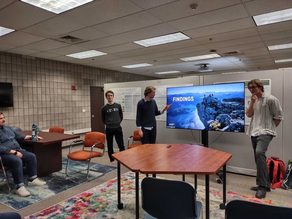Photo of people presenting at a seminar. 