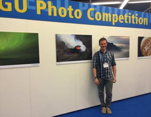 Morgan next to the winning areal photo of the Holuhraun volcanic eruption at Iceland in 2014. Photo: Morgan Jones and Sverre Planke, CEED