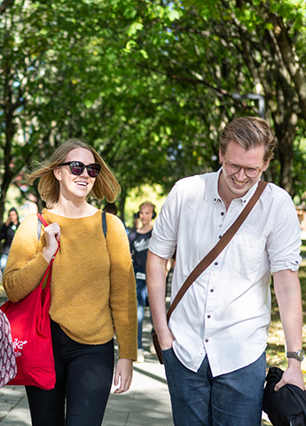 Two people walking outside
