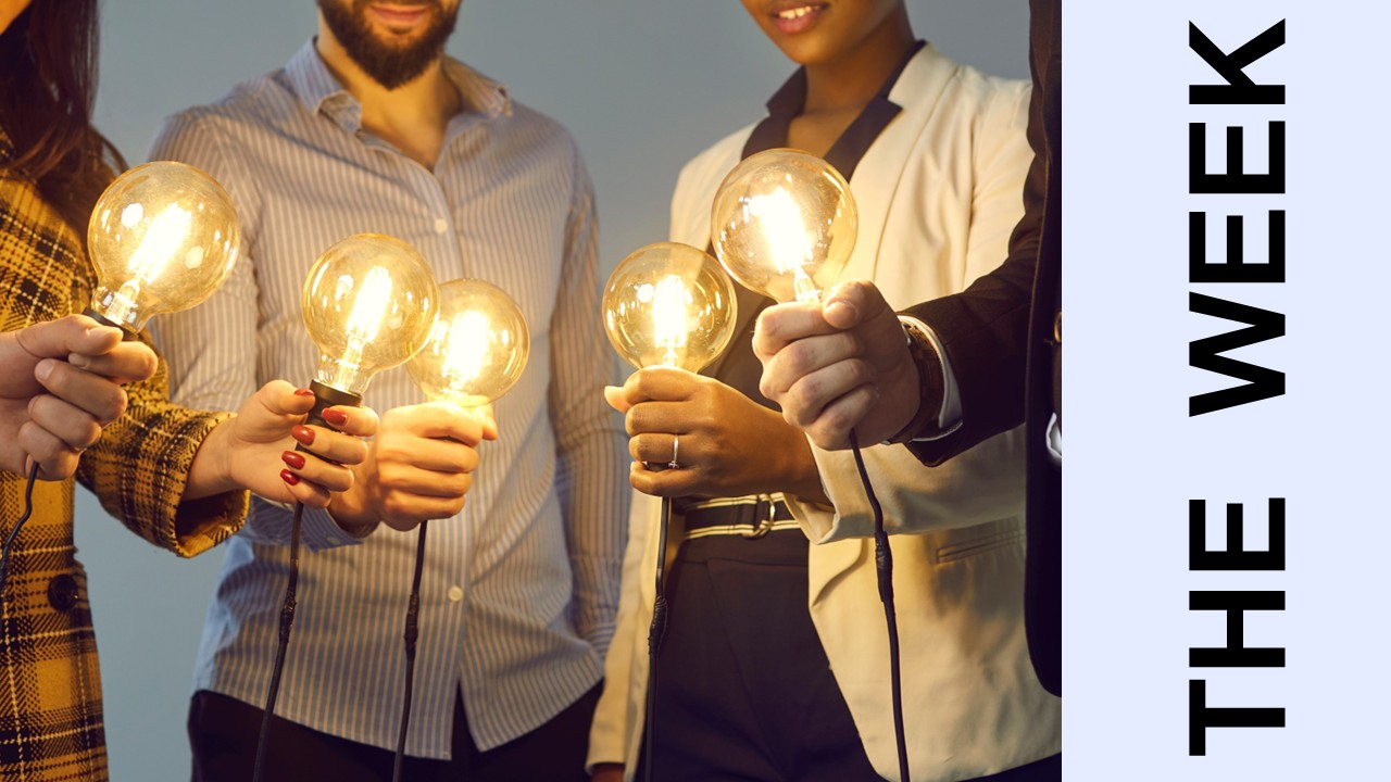 Photo of people holding large lightbulbs; text "THE WEEK" to the right
