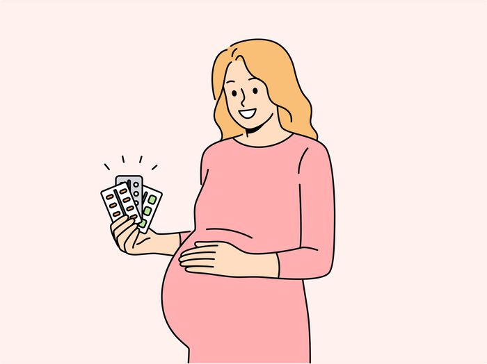 Pregnant woman with pills in hands (illustration)