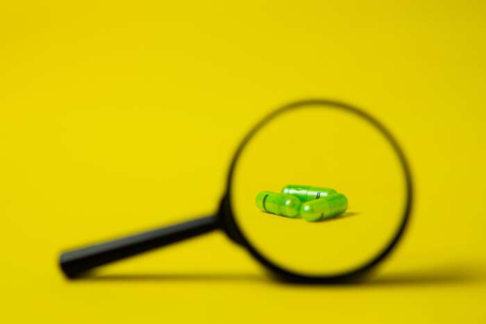 pills under magnifying glass