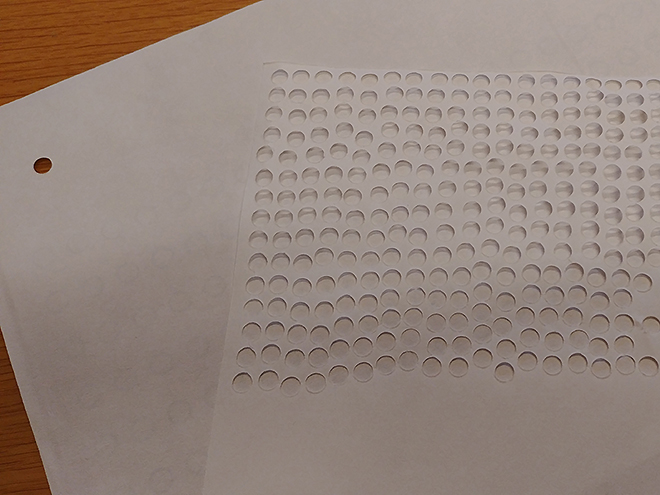 Sheets of paper with stamped holes