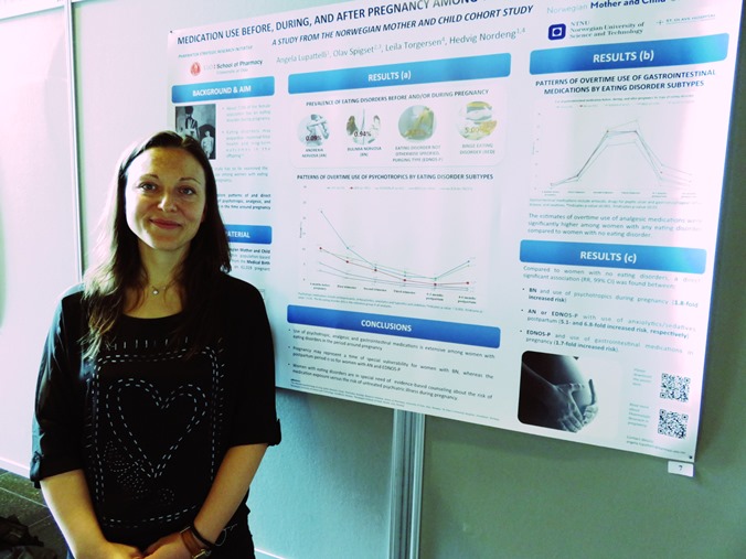 PhD candidate Angela Lupattelli standing in front of her poster