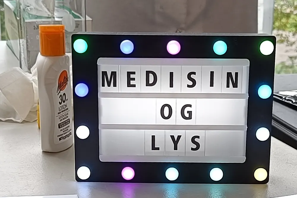 Ei lita lystavle med teksten "Medisin og lys"