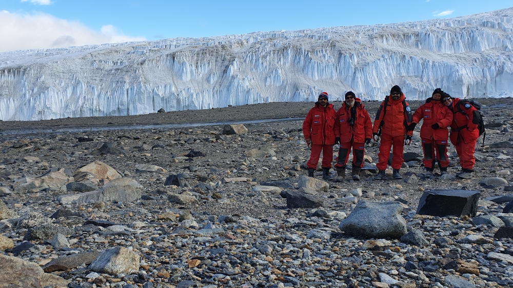 One of the Earth's most remote places – The  McMurdo Dry Valleys in the Antarctic continent. The picture show the SENECA research team in the extreme dry Taylor Valley site with the glacier Commonwealth Glacier in the background. Photo: SENECA/team