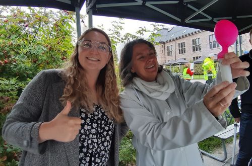 Cathy Braathen and Sian Evans inflating a balloon with CO2