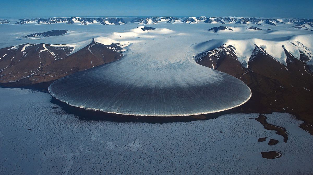 Photo: This image captures the Elephant Foot Glacier, a glacier located on the Kronprins Christian Land peninsula in northeastern Greenland. The glacier flows into the Romer Lake which is a land-locked freshwater fjord. Photo: Private | EarthFlows - Interface Dynamics in Geophysical Flows, photo of a galcier.
