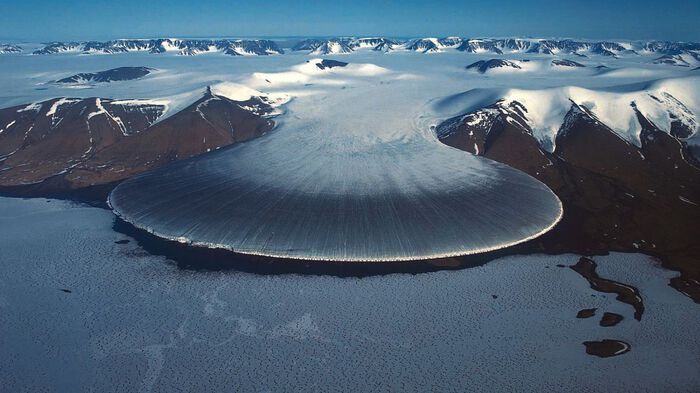 Photo: This image captures the Elephant Foot Glacier, a glacier located on the Kronprins Christian Land peninsula in northeastern Greenland. The glacier flows into the Romer Lake which is a land-locked freshwater fjord. Photo: Private | EarthFlows - Interface Dynamics in Geophysical Flows, photo of a galcier.