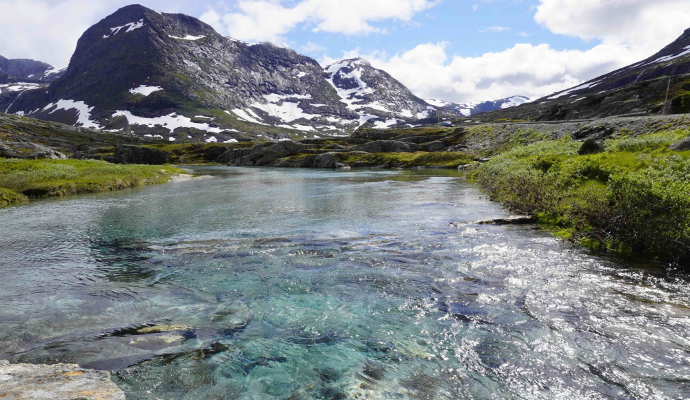 Photo: Small stream in Alnesdalen with the mountains of Trolltindan in the background. Photo: Juditha Aga/UiO