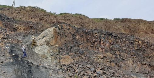 Geologists conducting field surveys in the Central Siberian Plateau. The photo shows a magmatic rock (intrusion) that has penetrated into sedimentary rocks that in the area have several layers of coal.