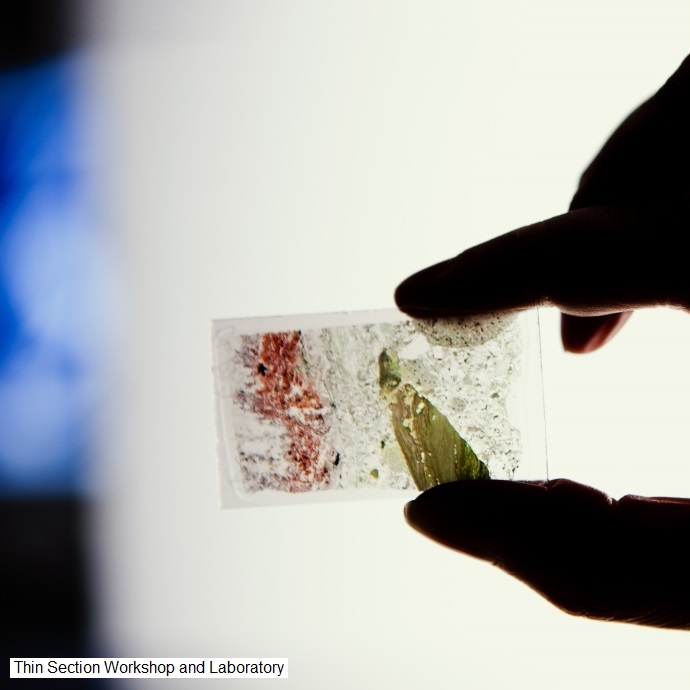 Image: A laboratory technician holds a thin section of minerals/rocks from the Thin Section Workshop and Laboratory, at Department of Geosciences, University of Oslo. Photo: Hans Fredrik Asbjørnsen/UiO