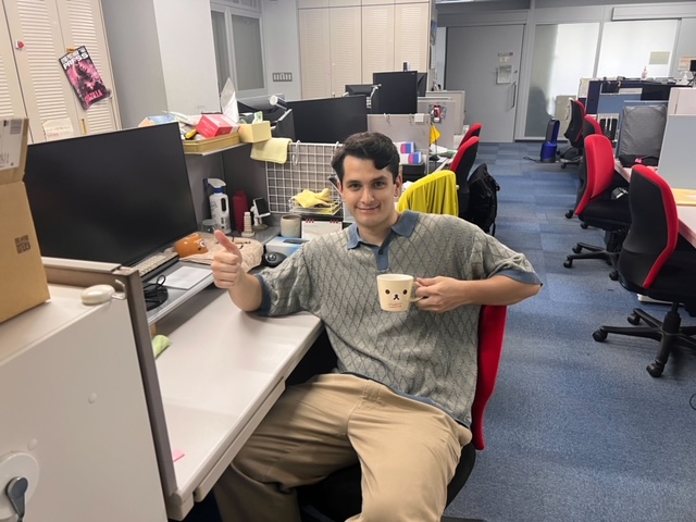 Image may contain: Computer, Office chair, Smile, Chair, Personal computer.