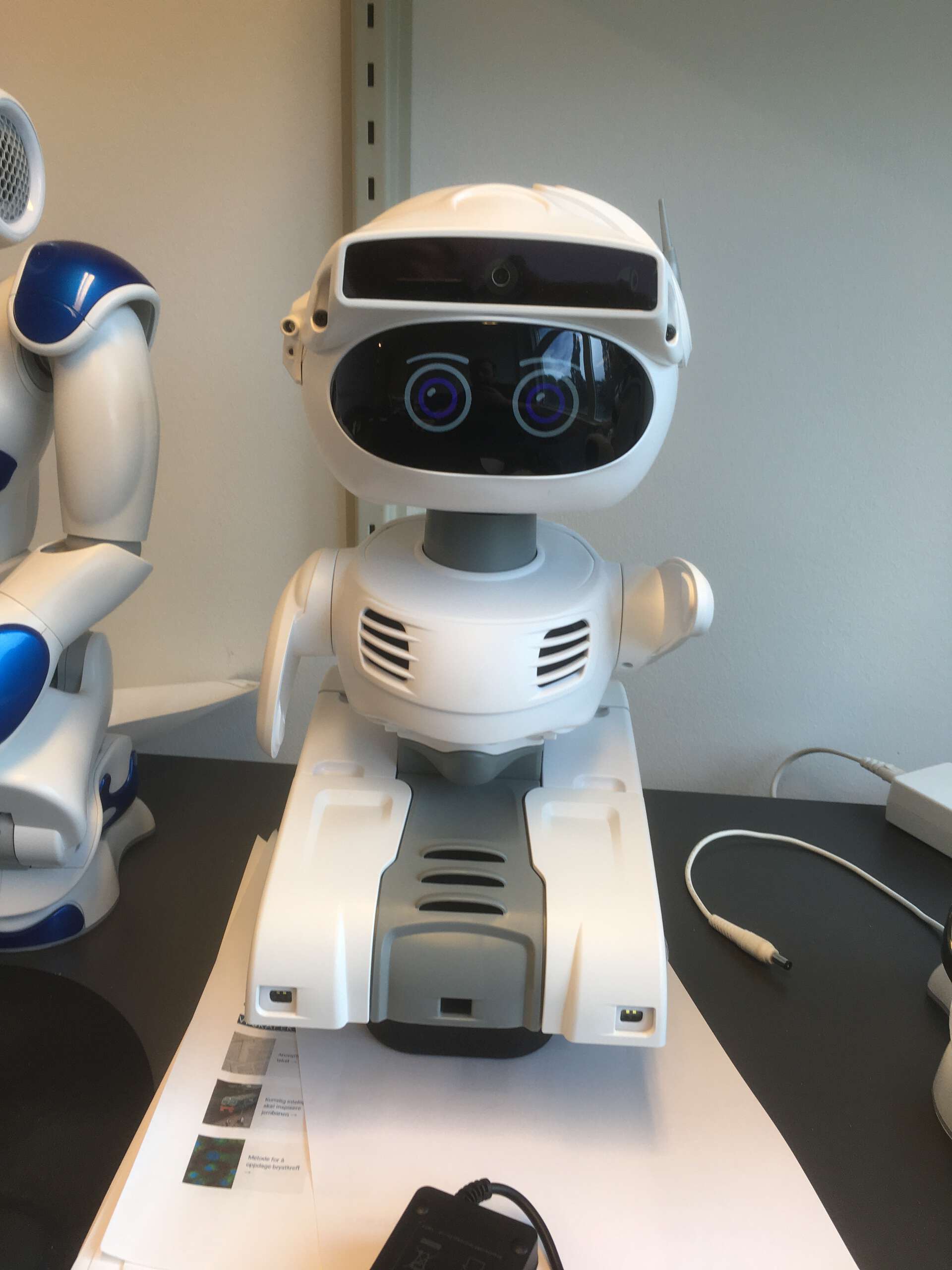 A Misty II robot looking at the camera and waving
