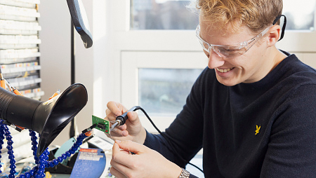A young man soldering