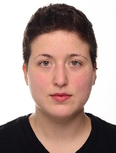 Image may contain: A person (Deniz) looking straight at the camera. They have short brown hair and are wearing a black crewneck shirt.