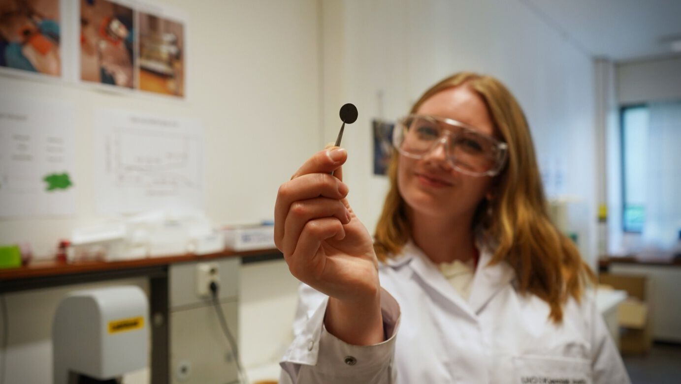 Picture shows Amalie holding a piece of a battery in her hand