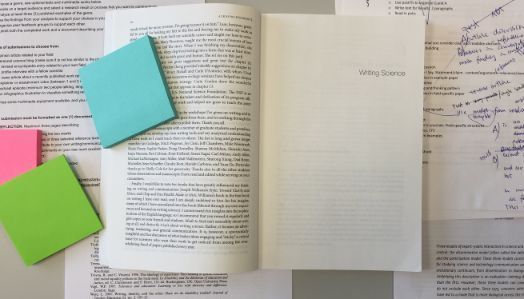 Illustrasjonsfoto viser dokumenter under arbeid, postIT-lapper, referanseliste og en åpen bok (Writing Science and Joshua Schimel).
