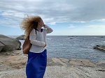 Image may contain: person, hair, water, cloud, sky.