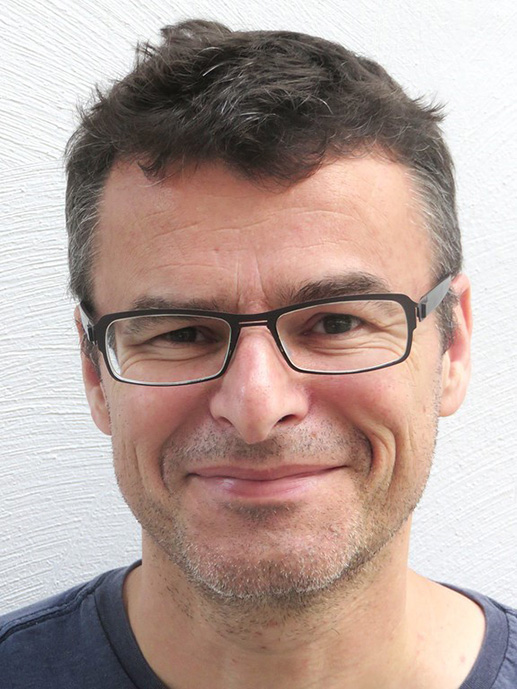 man with dark grey hair and glasses