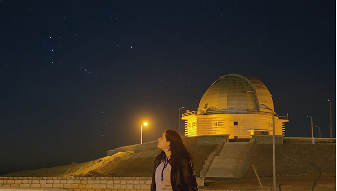 young researcher in front of observatory in Egypt