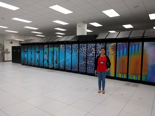 young female engineer in front of a super computer