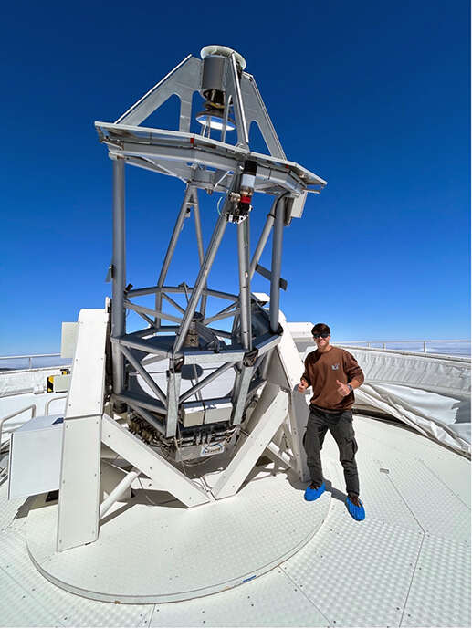 Young man in front of the two-meter Twin Telescope in Tenerife